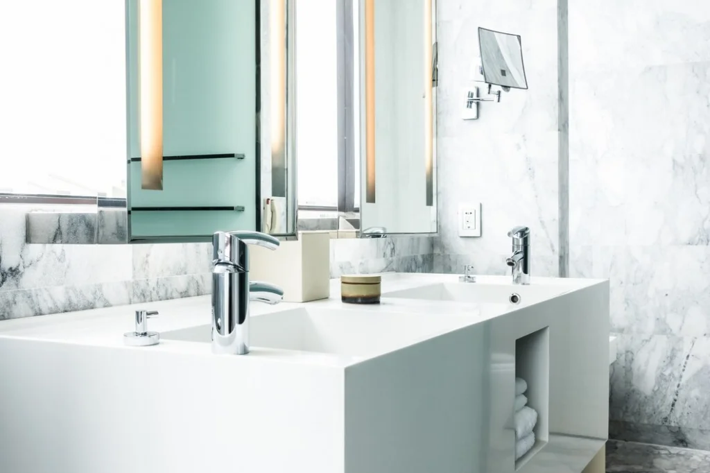 Faucet and sink on a bathroom countertop, representing the importance of following countertop maintenance tips.
